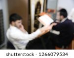 Small photo of A pair of Jewish students toil in Torah learning in their Yeshiva School using many religious books