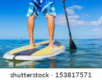 Young Attractive Mann on Stand Up Paddle Board, SUP, in the Blue Waters off Hawaii