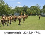 Small photo of East Java, Indonesia – August 6, 2023 : A photo of a group of scout children undergoing drill practice during a school extracurricular activity