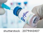 Small photo of Vials of liquid the logos pfizer and biontech in the doctor's hand. March 15, 2021. Barnaul, Russia.