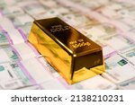 Small photo of gold bar on russian money background with 1000 rubles banknotes. gold and foreign exchange reserves