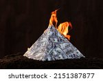 Small photo of A global financial pyramid based on the dominance of the dollar. World management concept. conspiracy theory. the collapse of the dollar's financial system. Money is burning on a dark background.