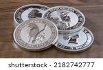 Small photo of Silver ounces of Australia on wooden table, silver coins, silver money