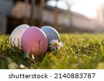 Happy Easter. Easter eggs on grass on a sunny spring day - Easter decoration, banner, panorama, background with copy space for text.