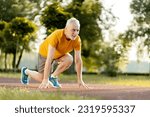 Small photo of Handsome Caucasian gray haired bearded senior athletic man, runner in sportswear, stands at the starting position on the treadmill, ready for morning run. Running. Jogging. Marathon. Cardio workout
