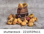 Still life of a group of macas in a rustic background together with an Andean sack