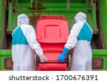 Small photo of worker wear PPE protective clothing against corona virus of Infectious waste garbage collector truck loading waste and trash bin.