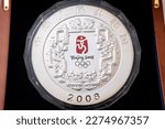 Small photo of 03132023 The photo was taken in Ukraine in the city of Lviv. coin on a white background. Silver coin 300 yuan 2008 XXIX Olympiad in Beijing. China. 1 kg