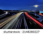 Freeway traffic on German roads at night - light trays during sun set and blue hour