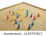Small photo of Cork board with scattered around thumbtack isolated on white background, copy space, timber cork pinboard, colorful pin thumbtacks