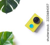 A yellow camera with two green...