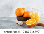 Small photo of front view fresh sliced orange on dark background ripe mellow fruit juice color citrus tree citrus, Whole and sliced ripe oranges placed on marble background, half orange fruit.