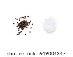 Dried whole seed of black pepper and white coarse sea salt isolated on a white background seen from above