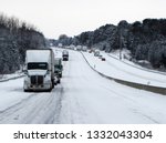 Major snow storm causes traffic delays on highway with an abundance of truck traffic.