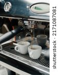 Small photo of Making coffee espresso or ristretto in coffee machine. Home making hot Espresso. Coffee with froth. Espresso in a white cup. Tasty coffee. Caffeine.