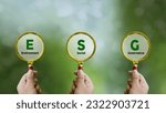 Small photo of Words ESG. on magnifier glass with green backgroud. Concept of environmental, social and governance. Sustainable and ethical business. account the environment, society and corporate governance.
