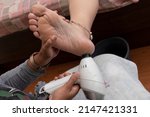 Small photo of Pedicure is using a foot grater to rub away dead skin cells from the foot.