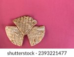 Small photo of corn tortilla chips isolated on a pink red background (cut out masa chip for dipping) restaurant style crunchy toasted yellow, white nixtamalized hominy (mexican food, totopos)