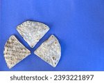 Small photo of corn tortilla chips isolated on a blue background (cut out masa chip for dipping) restaurant style crunchy toasted yellow, white nixtamalized hominy (mexican food, totopos)