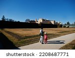 Three kids walking at Lednice park, Czech Republic.