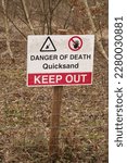 Small photo of Little Paxton, Cambridgeshire, England, March, 24th, 2023: Danger of death and quicksand warning sign at Paxton Pits.