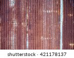 A rusty and weathered looking piece of corrugated metal.