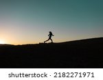 Girl Runs At Sunset In The...