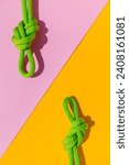 Small photo of two ropes with secure knots. concept of reliability and safety. climbing rope with a knot lies on a colored background. rope with a knot.