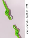Small photo of rope with a secure knot. concept of reliability and safety. climbing rope with a knot lies on a colored background. rope with a knot.