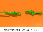 Small photo of two ropes with secure knots. climbing rope with a knot lies on a colored background. concept of reliability and safety. rope with a knot.