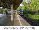 Small photo of Sopot, Poland - September 7 2022: Train station in Sopot. Passenger train departing with view of passengers leaving the platform. PKP SKM Trojmiasto electric trainset 31WE Newag Impuls.