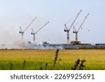 Small photo of Burning, fire destroying fields during severe drought Disasters regularly wreak havoc on the region's economy. The wheat field in the background is a crane. Prosperity is replacing the rice field.