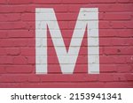White Letter M Painted To Brick ...