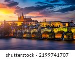 Charles Bridge sunset view of the Old Town pier architecture, Charles Bridge over Vltava river in Prague, Czechia. Old Town of Prague with Charles Bridge and Castle in the background, Czech Republic.