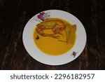 Small photo of Only one Bighead prawn also known in malay as Udang Galah,the fresh water food cooked with tumeric coconut milk in a wooden background