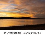 Small photo of The sun sets over Lake of the Arbuckle at Chickasaw National Recreation Area in Oklahoma