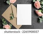 Invntation or greeting card mockup with envelope and roses flowers on dark background, blank mockup