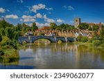 Small photo of The Church and Bridge over the river Medway at high tide at Aylesford Village in Kent England at High Tide