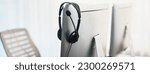 Small photo of Panorama view of empty call center operator workspace, focused on headset. Representing corporate customer service support and telesales communication technology. Prodigy