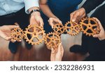 Small photo of Office worker holding cog wheel as unity and teamwork in corporate workplace concept. Diverse colleague business people showing symbol of visionary system and mechanism for business success. Concord