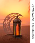 Small photo of Ramadan Lantern on the beach with crescent moon shape during sunset, 2024 Islamic concept image, Eid Mubarak Greeting background