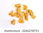 Zoomed-in View of Asian Fried Crispy Chicken Skin on a White Background