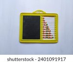 Closeup of Plastic Colorful Beeds for Abacus , Black Board Slate with Chalk Piece isolated on white background