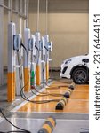 Small photo of EV charging an electric car. Power supply for electric car charging. Socket for electrical car battery charger. EV car charging station in parking. Nature energy, Clean energy, Green eco concept.