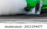 Small photo of Blurred car drifting diffusion race drift car with lots of smoke from burning tires on speed track, Professional driver drifting car on race track with smoke.
