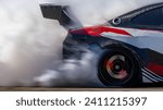 Small photo of Blurred car drifting diffusion race drift car with lots of smoke from burning tires on speed track, Professional driver drifting car on race track with smoke.