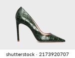 Small photo of Emerald pointy toe women's shoes with high heels isolated on white background. Green Female classic stiletto heels in crocodile skin leather. Single. Mock up, template