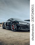 Small photo of Seattle, WA, USA May 23, 2023 Audi R8 parked showing the car wheel and red brake caliber