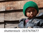 Small photo of Solukhumbu, Nepal - 10 Mar 2012 A Sherpa boy is watching outside. This kid is 5 years old