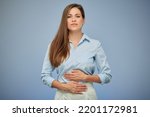 Young woman with stomach pain. isolated portrait on blue.